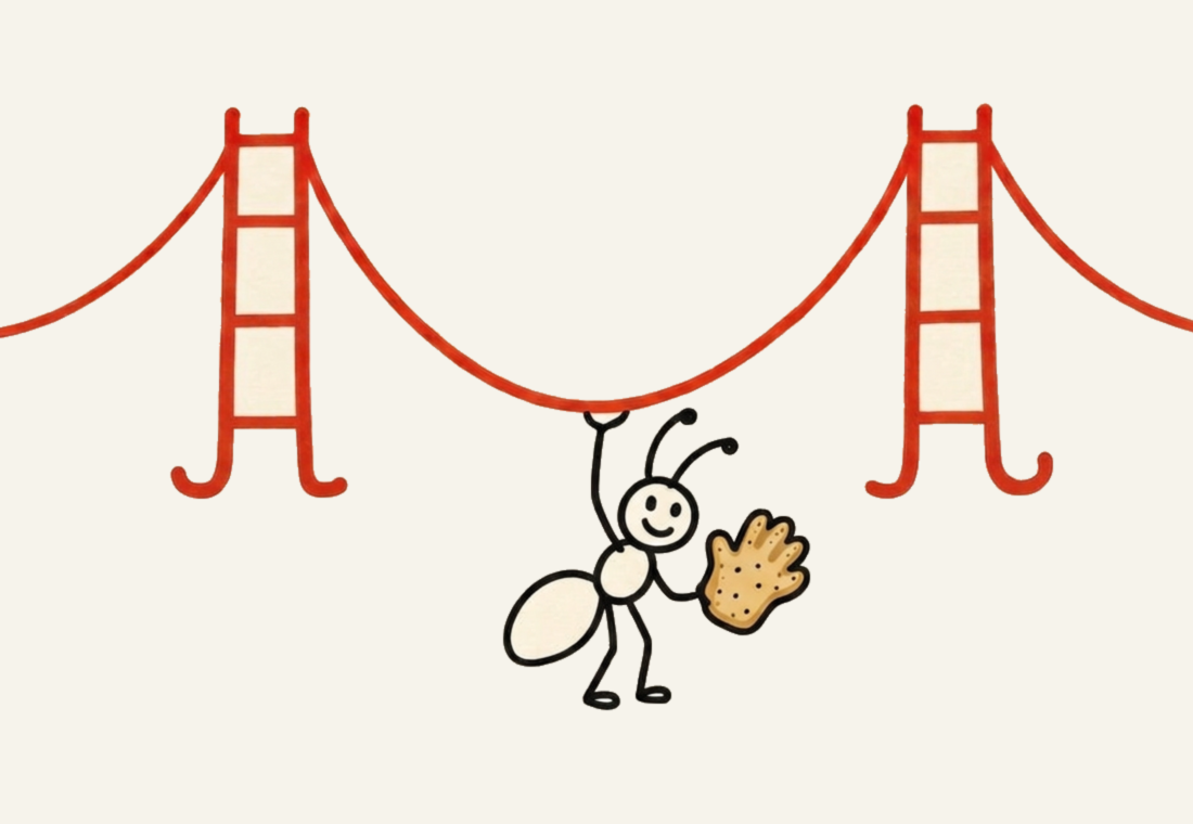 The SF ANT mascot: a happy ant holding up the Golden Gate Bridge with one arm and an Antwerp hand cookie in the other